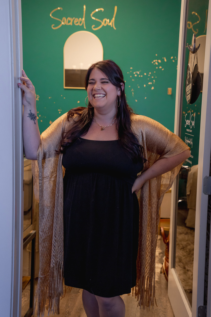 Kendall, owner of Sacred Soul Massage Therapy, standing in the doorway of her massage treatment room